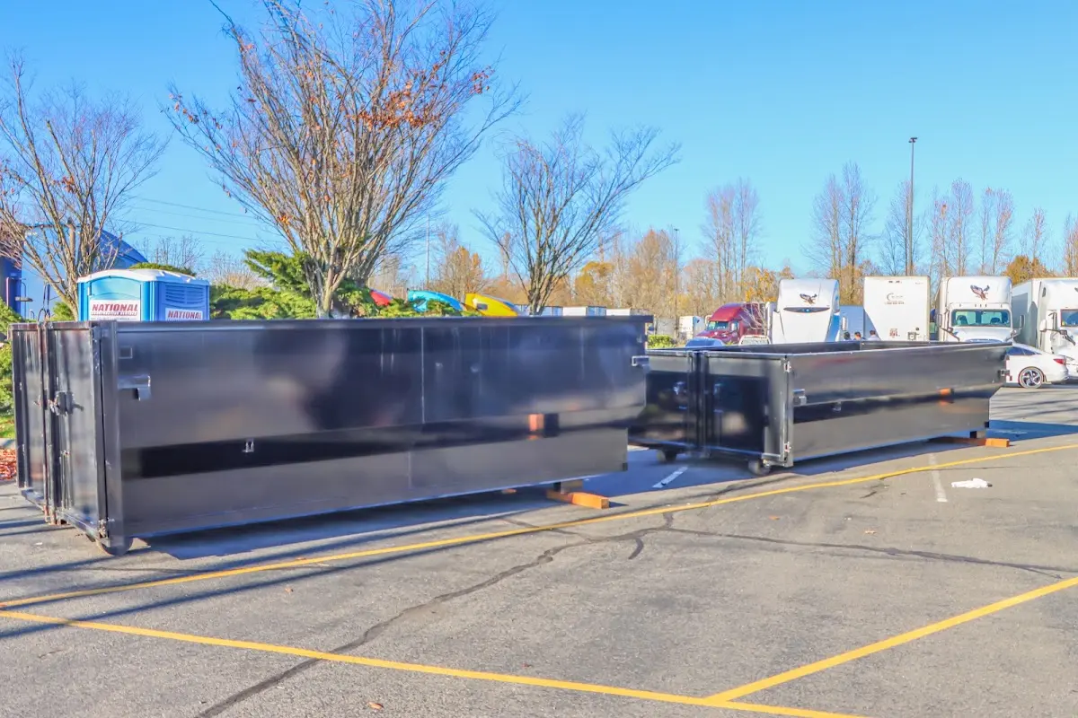 Professional dumpster rental service with roll-off container on residential driveway in West Columbia